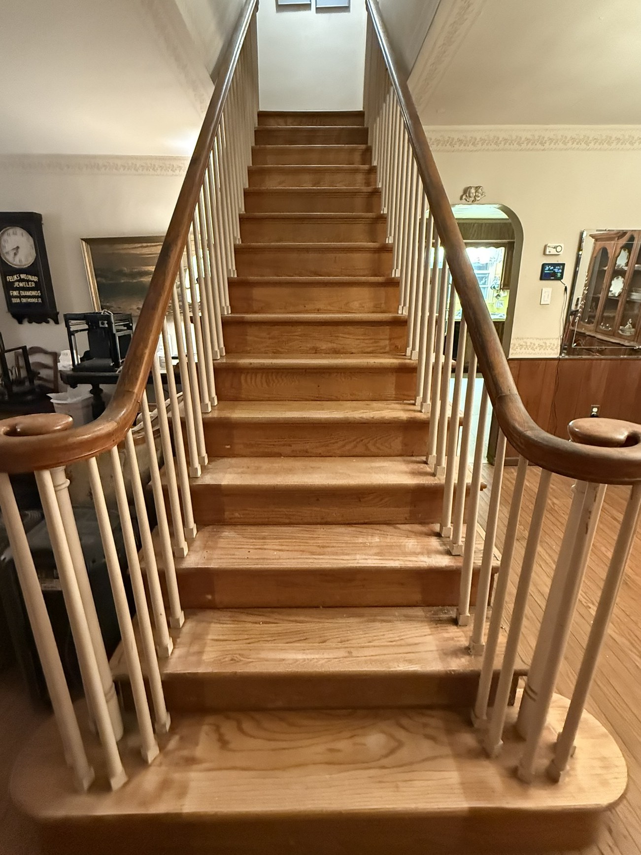 Oak staircase before refinishing: pale, worn treads