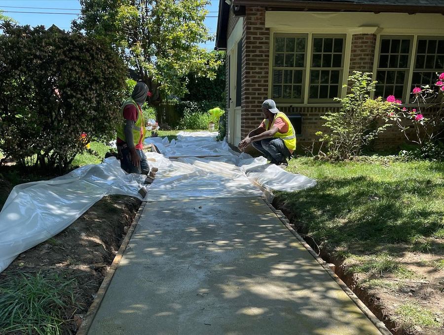 Crew finishing a fresh sidewalk pour